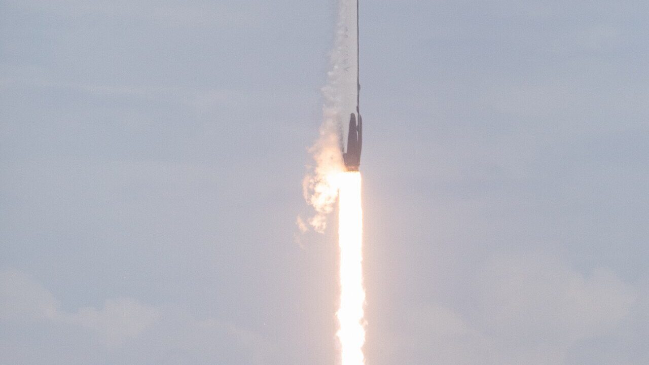 A Falcon 9 rocket ascending through the sky