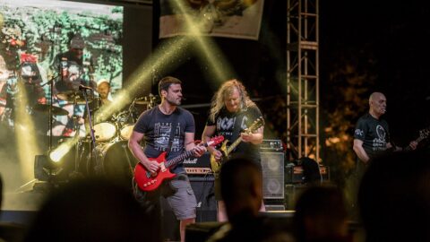 Musicians performing on stage at a night concert