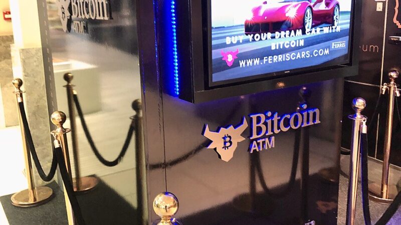 Bitcoin ATM kiosk with a glowing digital display