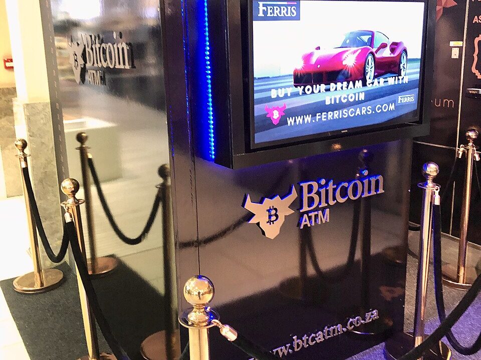 Bitcoin ATM kiosk with a glowing digital display
