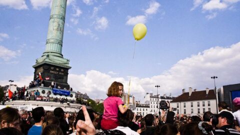 Crowd gathered at a demonstration in Paris in a public square