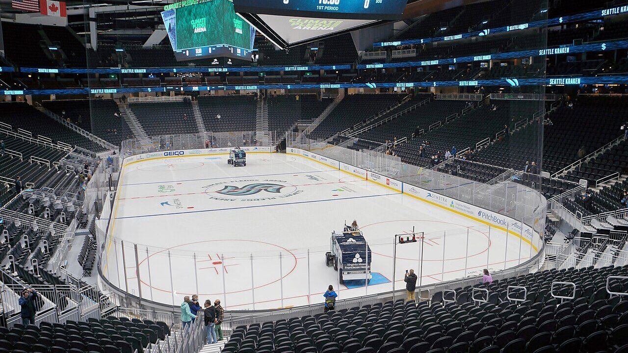Ice hockey rink inside Seattle's Climate Pledge Arena with the Kraken logo at centre ice