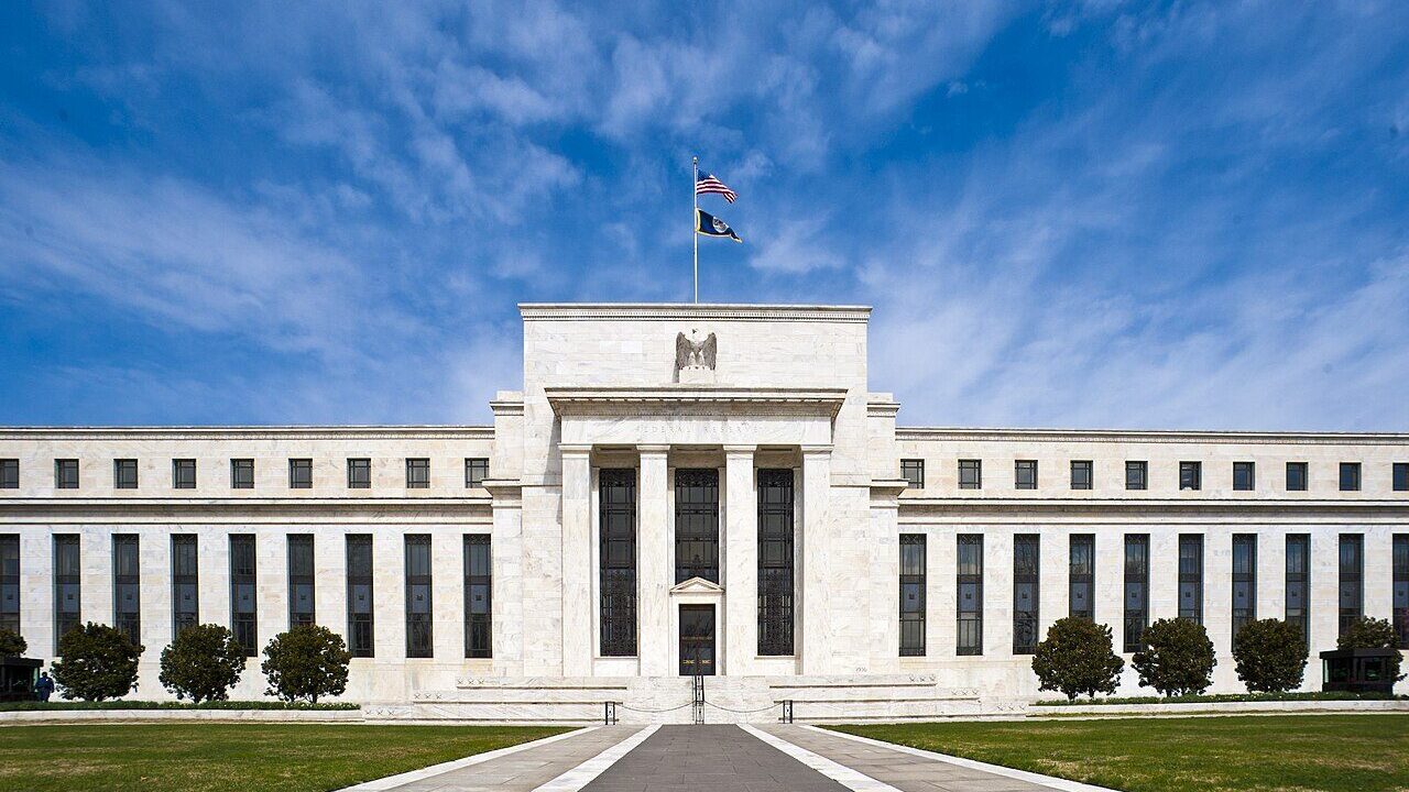 The Federal Reserve headquarters building in Washington DC under a blue sky