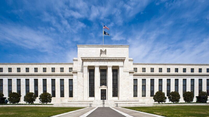 The Federal Reserve headquarters building in Washington DC under a blue sky