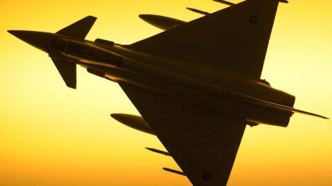 A Royal Air Force Typhoon fighter jet silhouetted against the sky