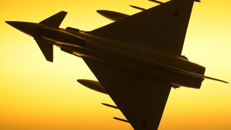 A Royal Air Force Typhoon fighter jet silhouetted against the sky